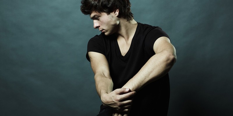 Fashion portrait of the young sexual man in studio